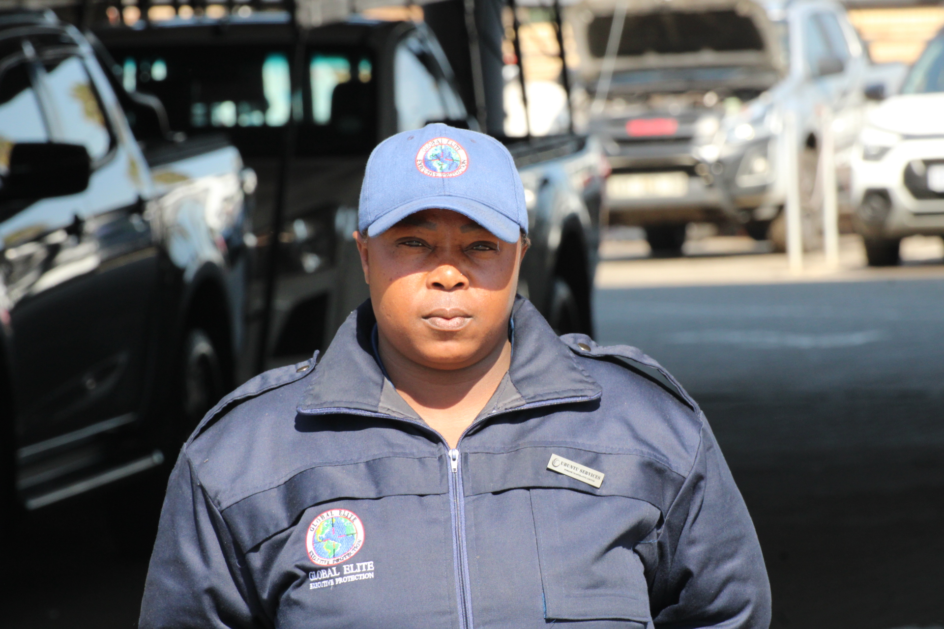 Professional female security officer representing Global Elite Executive Protection.