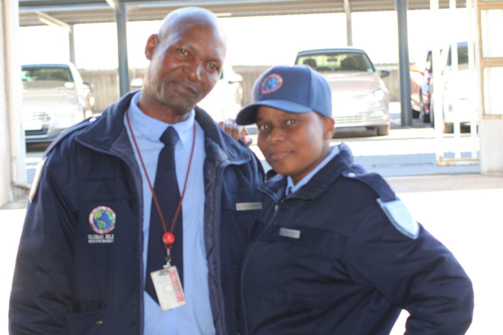 Uniformed Global Elite security guard standing next to Each other